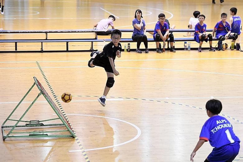 Junyuan Primary School's Grady Soon attempting a shot during the SPH Foundation National Primary School Tchoukball Championships senior boys' final against Alexandra Primary School at the Singapore Basketball Association in Aljunied yesterday. Junyua