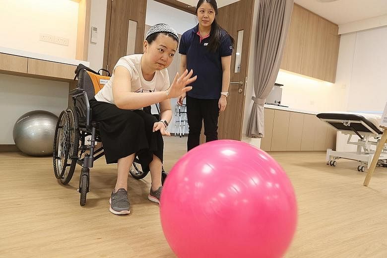 Stroke survivor Stephanie Lim, a participant of the Re-learn and Enjoy Active Living programme, going through a physical rehabilitation exercise at the new Stroke Wellness Centre in Jurong.