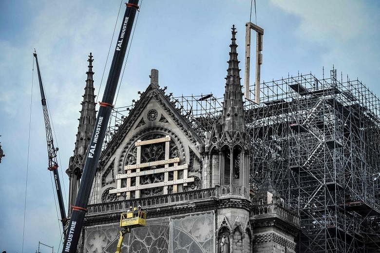 Repairs and renovations are under way at Notre Dame Cathedral in Paris. The landmark building lost its roof and spire in a huge fire last month, and an opinion poll shows that most respondents want the cathedral rebuilt exactly as it was before the d