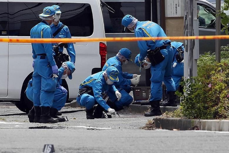 Top: Police at the scene where a knife-wielding attacker killed an 11-year-old schoolgirl and a man before taking his own life yesterday. The rampage outside Tokyo also left more than a dozen people injured. Left: A woman paying her respects to the v