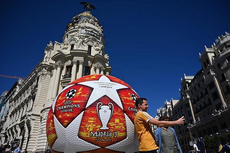 A fan taking a selfie yesterday with a giant replica of the Champions League ball displayed in Madrid ahead of Saturday's final.