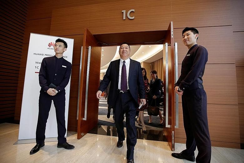 Huawei chief legal officer Song Liuping leaving after a news conference on the firm's ongoing legal action against the US government's National Defence Authorisation Act, at its headquarters in Shenzhen yesterday.