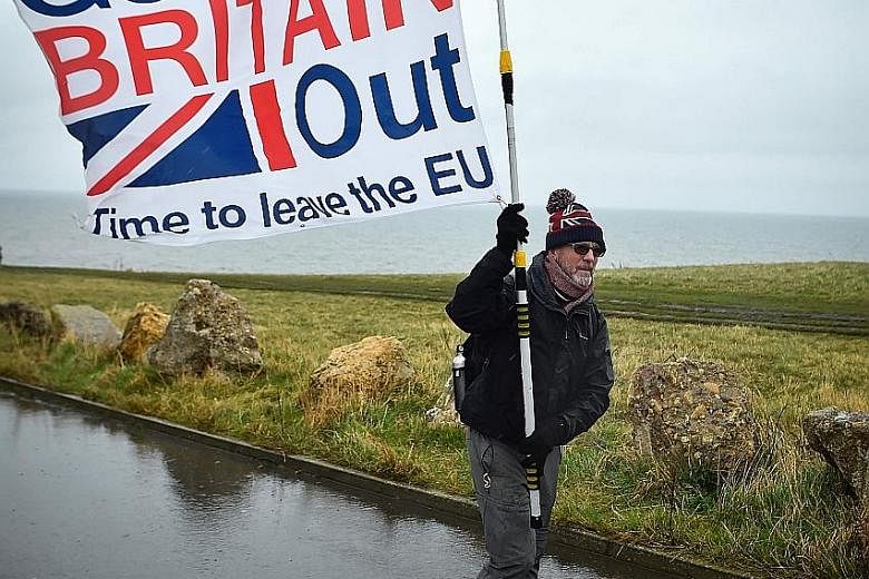 A campaigner during a "March To Leave" protest in Sunderland earlier this year. Brexit supporters admit there may be short-term disruption but that in the long term Britain would thrive outside the EU. PHOTO: AGENCE FRANCE-PRESSE