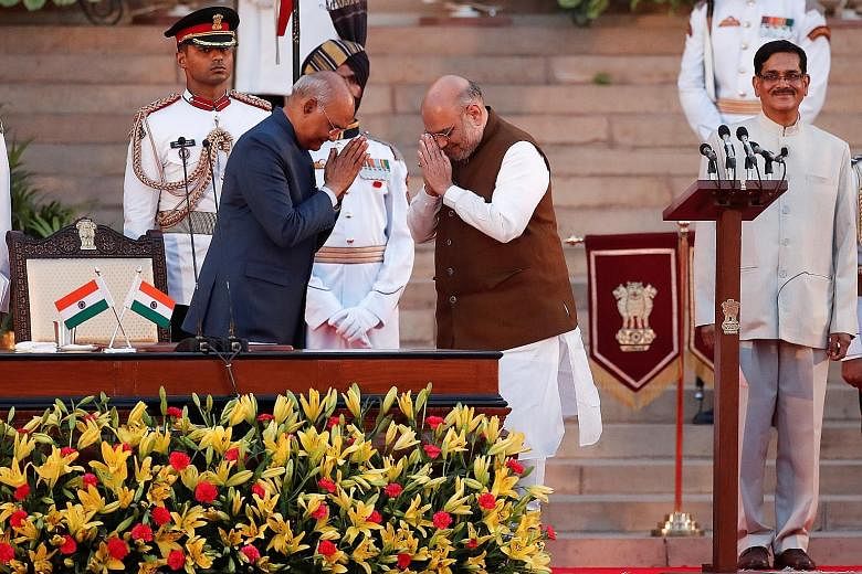 Indian President Ram Nath Kovind (left) greeting new Home Minister Amit Shah after his oath of office during the swearing-in ceremony at the Rashtrapati Bhawan, or presidential mansion, in New Delhi on Thursday. PHOTO: REUTERS