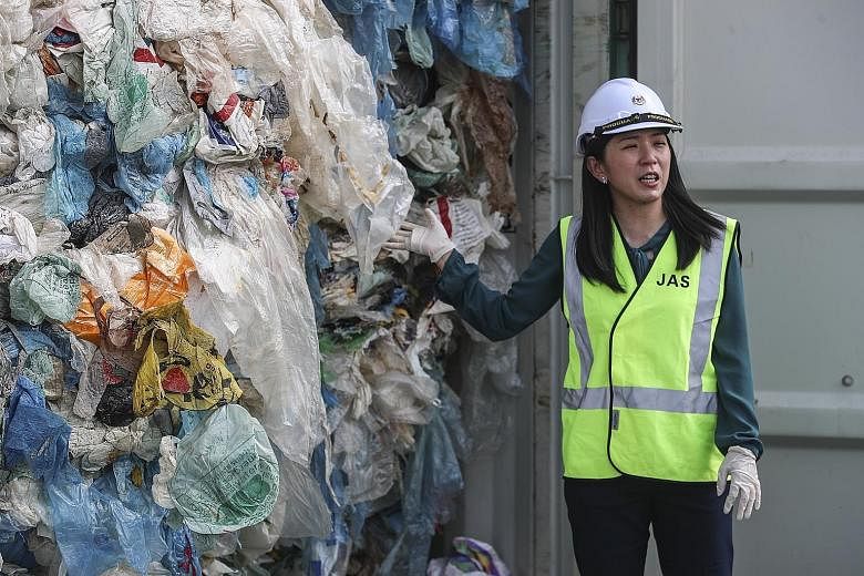 Malaysian Environment Minister Yeo Bee Yin showing the plastic waste inside a cargo container - which was due to be sent back to the country of origin - in Port Klang, Selangor, on Tuesday. She said a total of 3,000 tonnes of plastic waste from some 