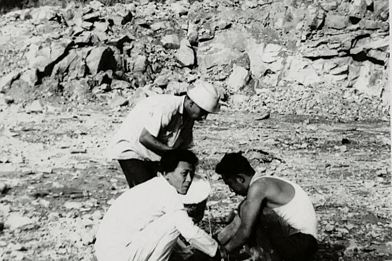 Quarry workers prepare for rock-blasting on the island - the material was used to build flats and roads on the mainland.