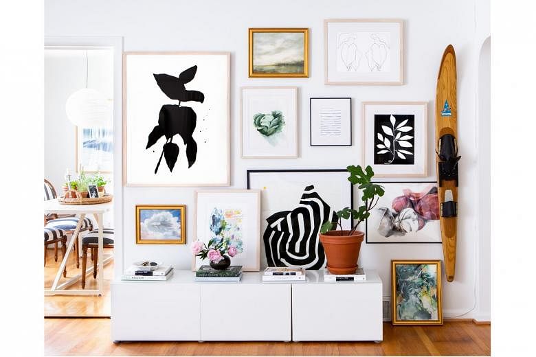 A gallery wall by online company Artfully Walls at a home in Ann Arbor, Michigan.