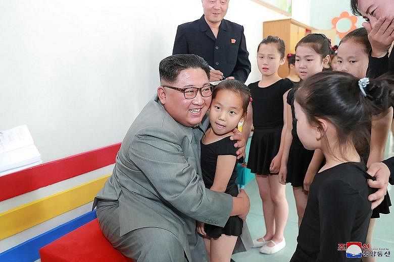 Another undated picture released by KCNA showing Mr Kim interacting with a group of girls during his visit to the 250-mile Journey for Learning Schoolchildren's Palace in Jagang province.