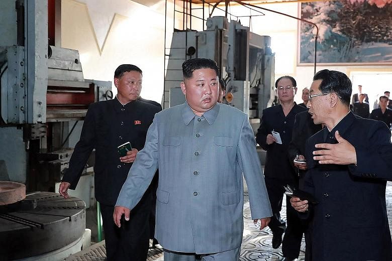 This undated picture released by the official Korean Central News Agency (KCNA) yesterday shows leader Kim Jong Un visiting Jangjagang Machine Tool Factory in Jagang province, North Korea. The news agency did not say when the visit happened.