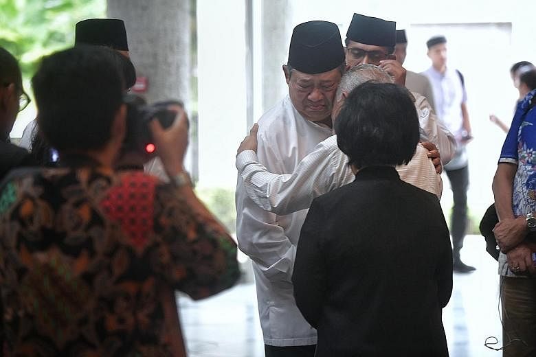 Dr Yudhoyono greeting well-wishers at the Indonesian Embassy yesterday after the final prayer rites for his late wife.