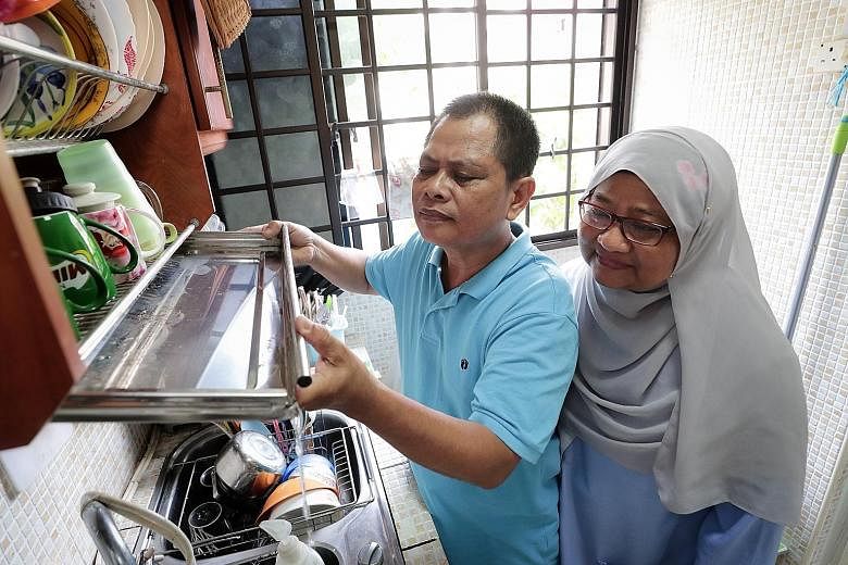 Chai Chee Road resident Zainodin Mohamad, 56, and his wife, Madam Sumarni Surana, 55, checking their kitchen for potential mosquito breeding habitats. The Chai Chee Road area is the third largest dengue cluster in Singapore. The first two are in Wood