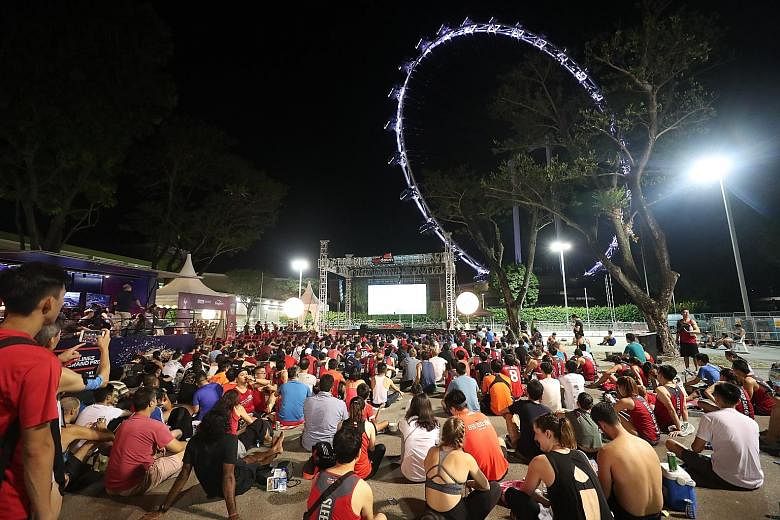 Above: Fans watching the final at the Sundown Marathon runners' village. Left: Reds fan Dinesh Kumar and father Dewadas Vellasamy, who supports Spurs, in Madrid.