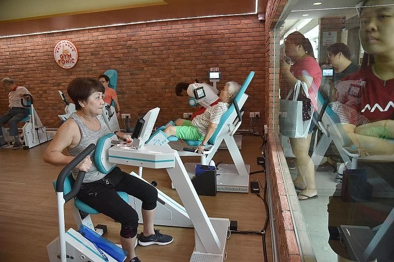 Residents doing strength training exercises in the Gym Tonic programme at the Touchpoint @ AMK 433 community hub, including Ms Rose Lee Kar Lan (in grey top), 61, and Ms Tan Yah Poh (in green shorts), 70.