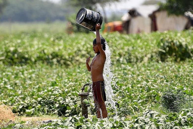An Indian boy trying to cool himself off amid rising temperatures in New Delhi last Wednesday. Several cities in Rajasthan were above 47 deg C. PHOTO: AGENCE FRANCE-PRESSE