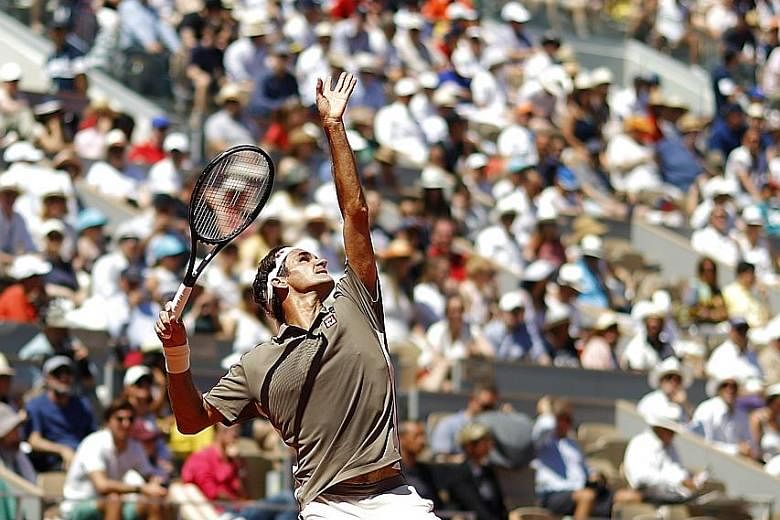 Switzerland's Roger Federer serving to Argentina's Leonardo Mayer in their fourth-round French Open match. The former world No. 1 won 6-2, 6-3, 6-3 without having to face a break point from his 68th-ranked opponent.