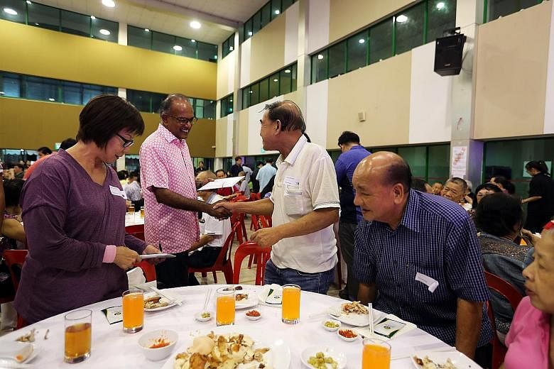 Transport Minister Khaw Boon Wan giving a resident her Merdeka Generation Package at ACE The Place Community Club in Woodlands yesterday, where 250 Sembawang GRC residents received their packages. ST PHOTO: CHONG JUN LIANG Home Affairs and Law Minist
