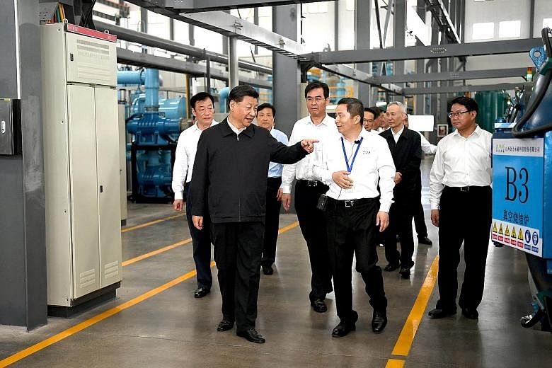 Chinese President Xi Jinping visiting a rare earth processing facility in Ganzhou, Jiangxi province, last month. Also present was Vice-Premier Liu He (in the background, wearing black). Many see the visit as a signal that if Washington does not back 