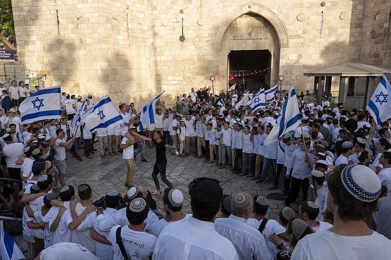 Right-wing youth dancing with Israeli flags on their way to the Western Wall during celebrations marking Jerusalem Day on Sunday. The day marks the reunification of Jerusalem and the establishment of Israeli control over the Old City after the 1967 S