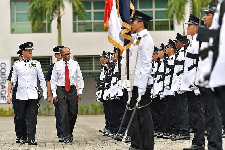Above: Clementi Police Division commander Jarrod Pereira (left) and Jurong Police Division's NS commander Teo Chai Jing lead two of the award winners. Right: Home Affairs and Law Minister K. Shanmugam was guest of honour at the Police Day Parade 2019