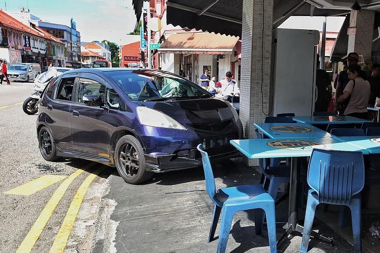 A driver lost control of her car along Geylang Road, which mounted the kerb and crashed into ABC Bistro. PHOTO: LIANHE ZAOBAO