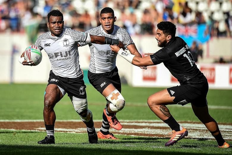 Fiji's Jerry Tuwai (left) is pursued by Ngarohi McGarvey Black of New Zealand during the Paris Sevens final. PHOTO: AGENCE FRANCE-PRESSE