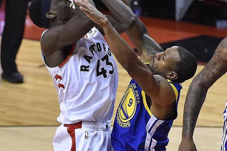 Golden State's Andre Iguodala (right) fighting for the ball with Toronto's Pascal Siakam during Game 2 of the NBA Finals. Warriors won 109-104. PHOTO: EPA-EFE