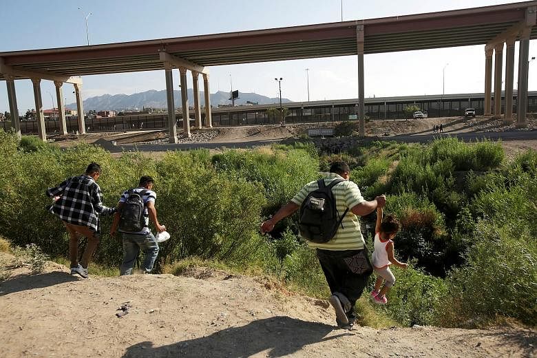 Migrants making an illegal crossing last week from Ciudad Juarez in Mexico to the United States, where they planned to turn themselves in to request asylum in El Paso, Texas. Talks between the US and Mexico were slated to kick off yesterday with a me