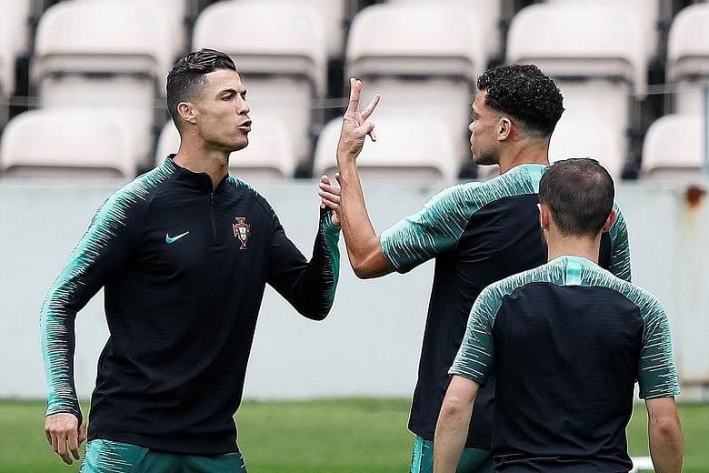 Portugal's Cristiano Ronaldo (left) and Pepe during training for today's Nations League semi-final against Switzerland. The other tie sees the Netherlands play England. PHOTO: REUTERS