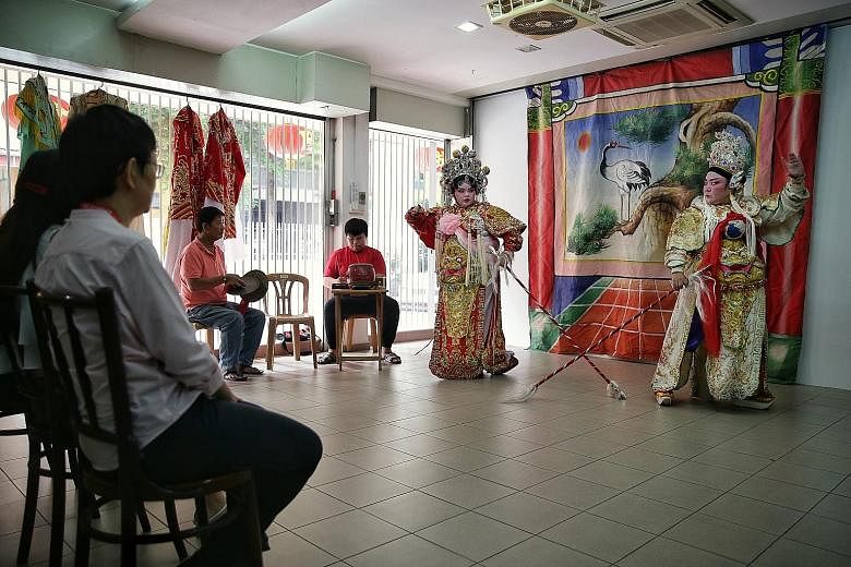 Sin Ee Lye Heng Teochew Opera's Ms Tina Quek (far right), 50, and daughter Christine Ang, 21, performing for participants of a heritage tour organised by Xperience Singapore recently. Such tours are evolving from just taking people to visit places to