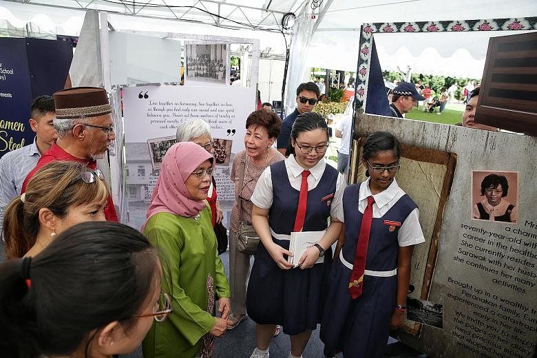 Above: President Halimah Yacob visiting the booth of the Paya Lebar Methodist Girls' School (Secondary) at the Istana open house yesterday. It was among several booths set up in conjunction with Singapore's bicentenary and showcased stories of how ed