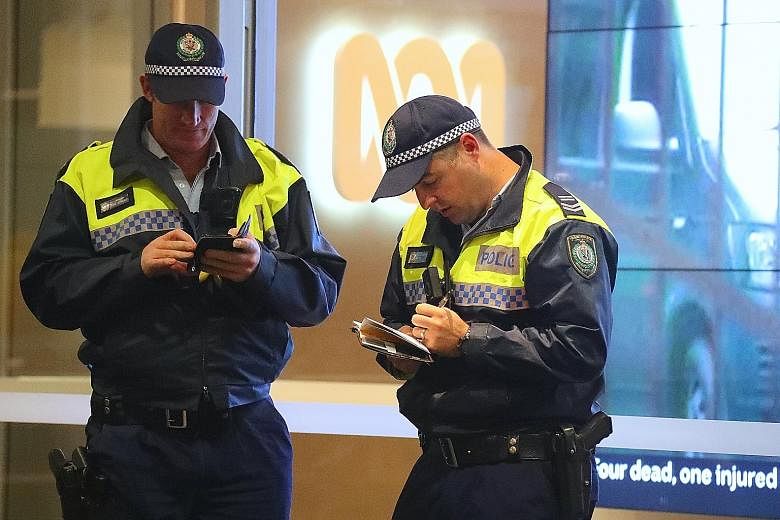 Policemen outside the ABC building in Sydney yesterday. The broadcaster was raided over claims that it had published classified material. PHOTO: EPA-EFE