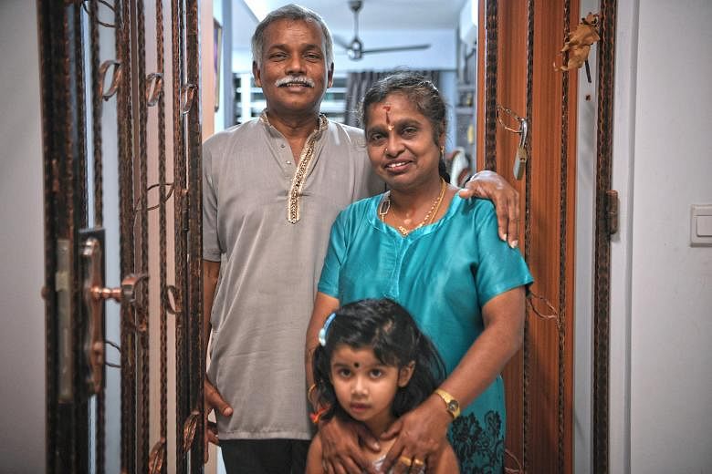 Madam Senthamizhselvi, 55, with husband Govindasamy Shanmugam, 59, and their granddaughter, Kayal Gobiraj, three, at the couple's purchased flat in Block 182A Woodlands Street 13, the only HDB block thus far with both rental and purchased units. She 