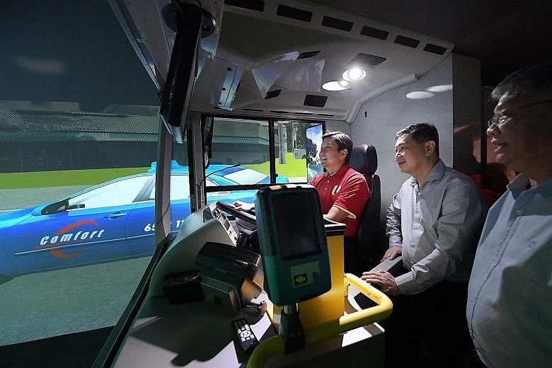 NTUC secretary-general Ng Chee Meng trying out a simulator at the Bus Training and Evaluation Centre during a visit to the Devan Nair Institute for Employment and Employability yesterday. Accompanying him was SMRT Roads president Tan Kian Heong. Truc