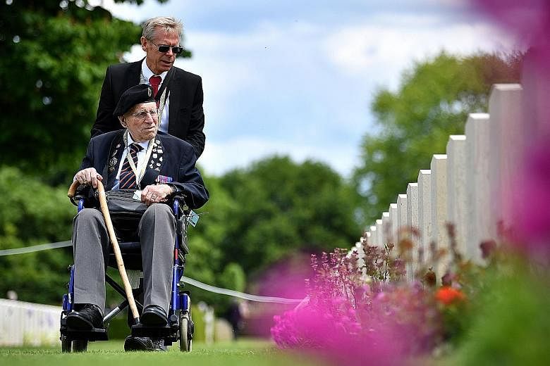 A British army veteran looking at the graves of fallen soldiers during a Service of Remembrance yesterday at the Commonwealth War Graves Cemetery in Bayeux, in Normandy, north-western France, during the commemorations of the 75th anniversary of the D