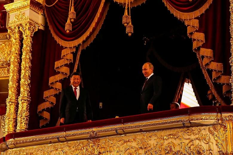 Russian President Vladimir Putin and his Chinese counterpart Xi Jinping at a ceremony on Wednesday at the Bolshoi Theatre in Moscow. The event was dedicated to the 70th anniversary of the establishment of diplomatic relations between the two countrie