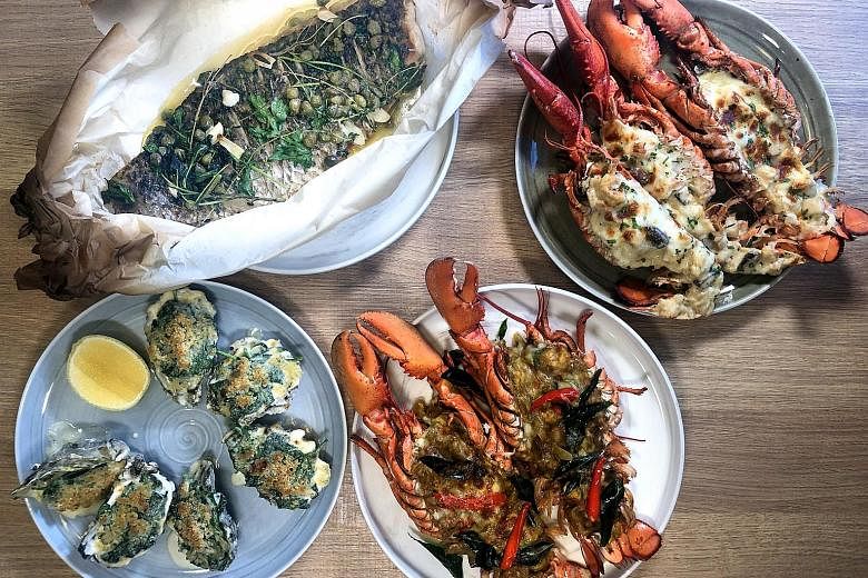 (Clockwise from top left) Baked Whole Seabass with burnt butter and capers, Lobster Thermidor, Curry Lobster and Oyster Rockefeller are highlights of the Father's Day Brunch at Sky22 at Courtyard by Marriott Singapore Novena. The grilled ox tongue at