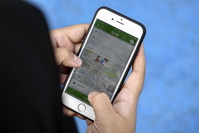 Singaporeans will have to comply with the rule requiring selfie verification when using the Grab app in Malaysia. On its website, Grab said the selfie is for safety and may be used to assist the authorities when required. PHOTO: BERNAMA
