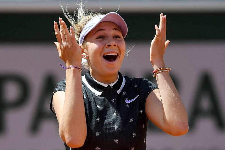 American Amanda Anisimova, 17, celebrating after ousting defending champion Simona Halep of Romania from the French Open yesterday. Anisimova won their quarter-final clash 6-2, 6-4. PHOTO: AGENCE FRANCE-PRESSE