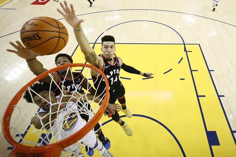 Golden State's Quinn Cook attempting a shot while under pressure from Kyle Lowry (No. 7) and Danny Green of Toronto in Game 3 of their NBA Finals clash on Wednesday. The Raptors won 123-109 to take a 2-1 lead in the series.