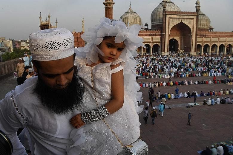 An Indian Muslim and his daughter at New Delhi's Jama Masjid mosque during Eid al-Fitr on Wednesday. Official data shows that India's Muslims fare worse than other religious communities in the country, and their continued marginalisation threatens to