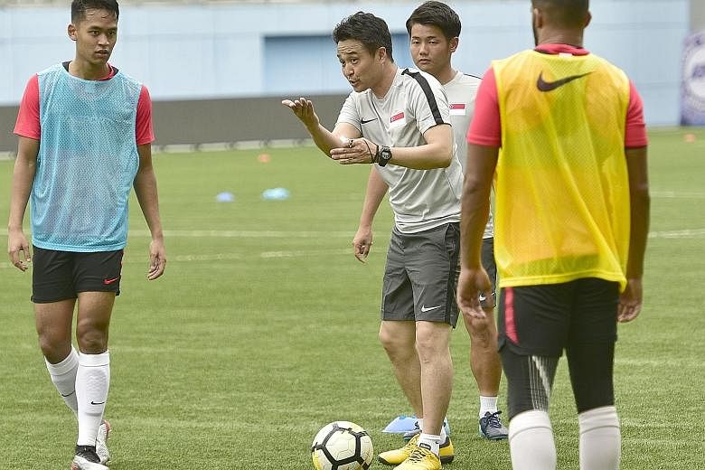 New Singapore football coach Tatsuma Yoshida, with translator Ryo Ishibashi, during his first training session with the players.