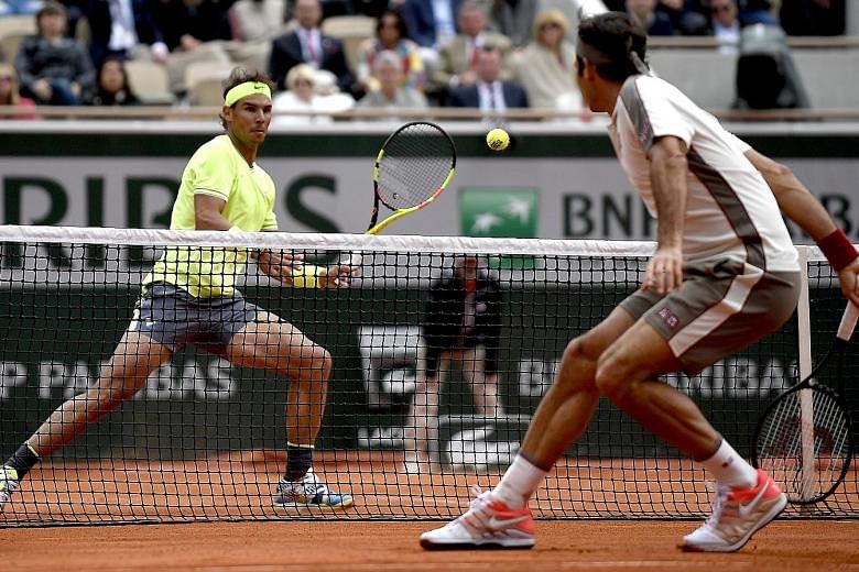 Rafael Nadal preparing for a forehand against Roger Federer in their French Open semi-final in Paris yesterday. His record at Roland Garros is now a staggering 92-2 and he is gunning for a 12th title.