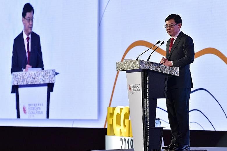Mr Heng Swee Keat speaking at the FutureChina Global Forum yesterday. He said the world's progress over the past decades could unravel if the key challenges are not managed well. ST PHOTO: NG SOR LUAN