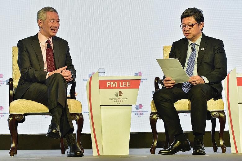 Prime Minister Lee Hsien Loong at a dialogue during the Business China Awards gala dinner last night with Business China director Robin Hu, who moderated the dialogue. ST PHOTO: DESMOND WEE