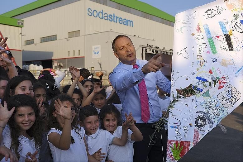 SodaStream CEO Daniel Birnbaum flying "peace kites" with Jewish and Muslim children outside the company factory near Rahat, Israel, last year.