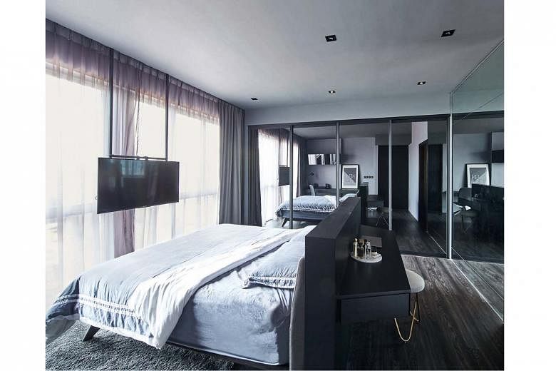 The home owners wanted the comfort of a hotel room, so a king-size bed and a suspended television set (above) were on their wish list. To accommodate the mattress size and extra wardrobe space, the master bedroom was combined with the adjacent room.