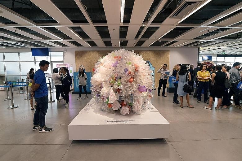 A sculpture made of plastic bottles and plastic bags at Ikea Tampines yesterday. Last year, about 164,500 tonnes of domestic waste here was made up of disposables - enough to fill about 300 Olympic-size swimming pools.