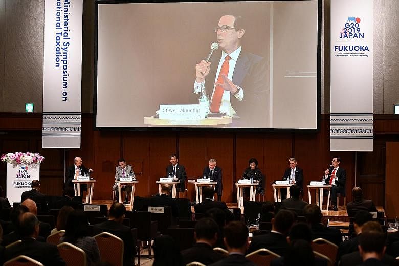US Treasury Secretary Steven Mnuchin (right, on podium) delivering a speech during the G-20 Ministerial Symposium on International Taxation in Fukuoka, Japan, yesterday. PHOTO: REUTERS