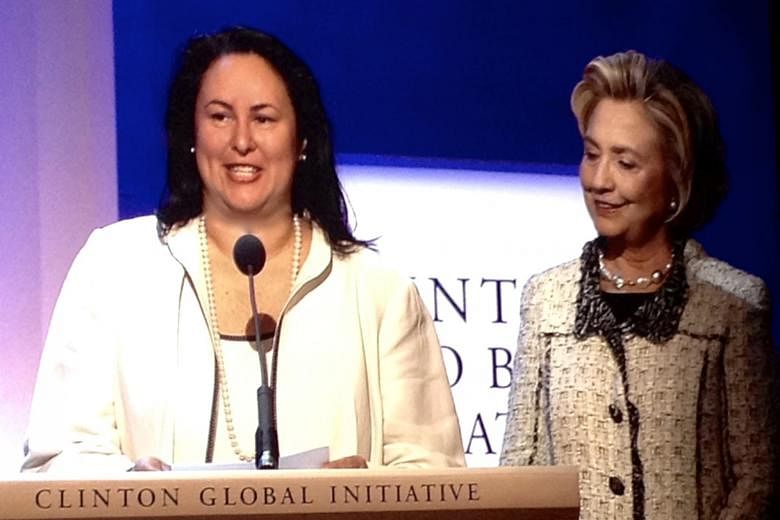 Ms Elizabeth Vazquez, seen here in 2013 with Mrs Hillary Clinton, is an adviser to the Clinton Global Initiative, which seeks solutions to global problems. Ms Elizabeth Vazquez is co-founder and chief executive of WEConnect International, the only co