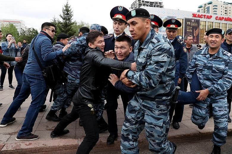 Opposition supporters clashing with police yesterday at a protest during the presidential election in Nur-Sultan, Kazakhstan. PHOTO: EPA-EFE